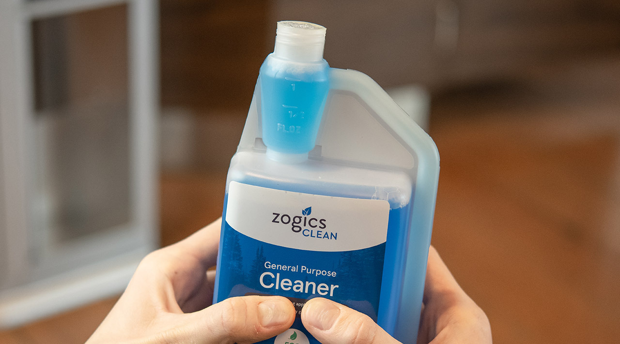 Custodian measuring floor cleaner concentrate at a dilution station Custodian measuring floor cleaner concentrate at a dilution station